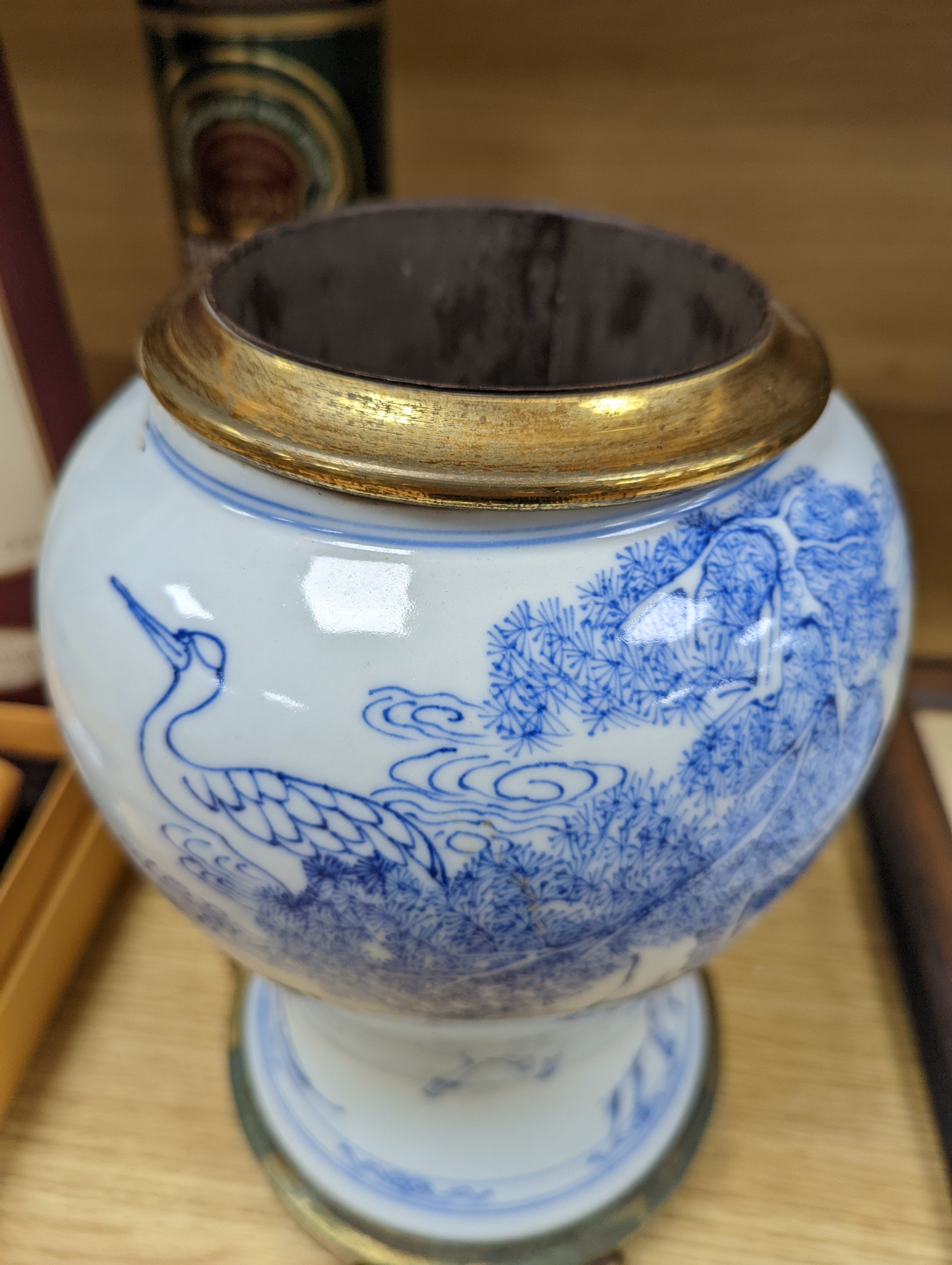 A Chinese blue and white baluster vase, brass mounted 29cm